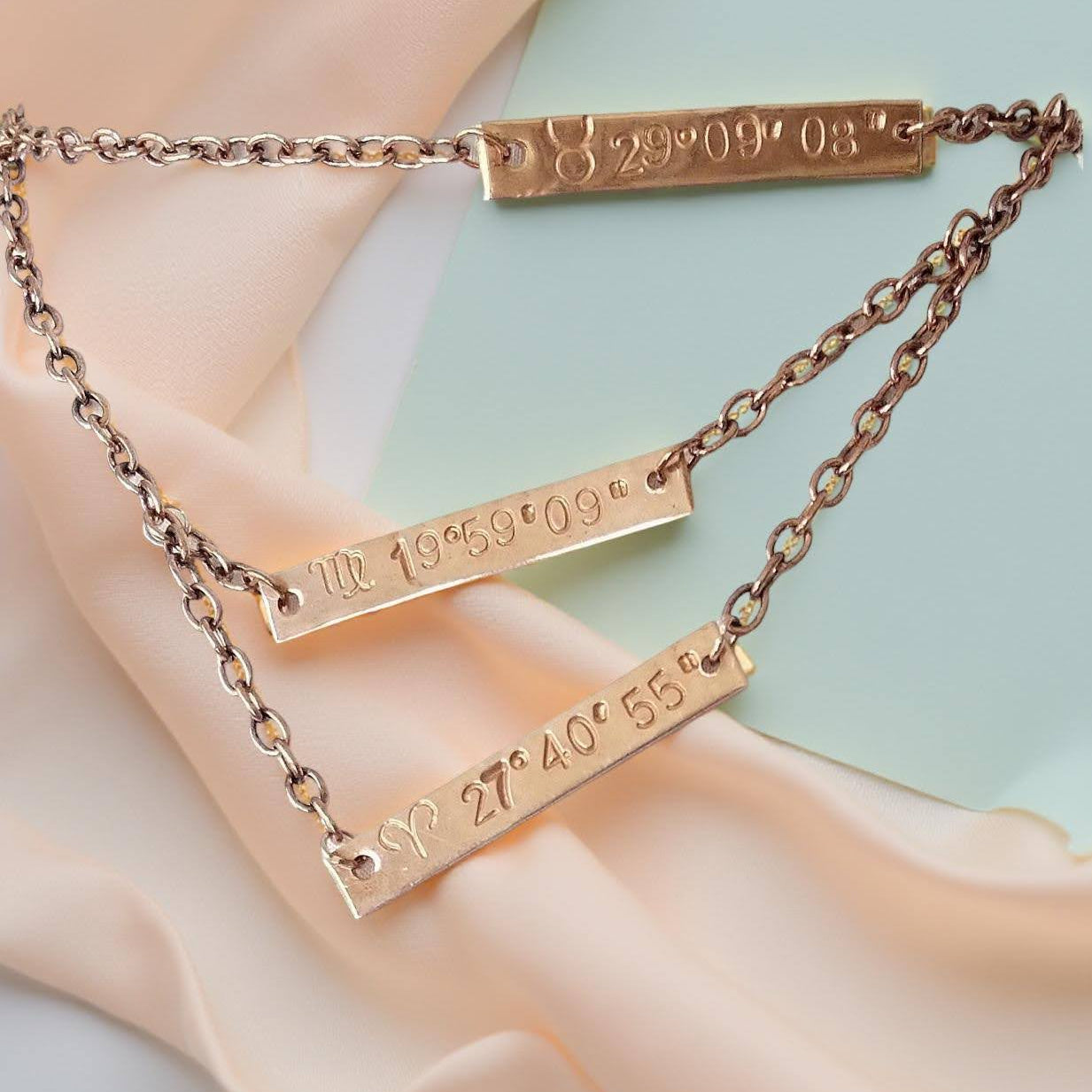 Personalized copper plaques 1 1/2 X 1/4th inch hand stamped zodiac sun sign and the degree of the sun at birth. With options of additional plaques for other family members or friends on a 16 inch, 18 inch and 20 inch (ect)  multi chained single necklace.    