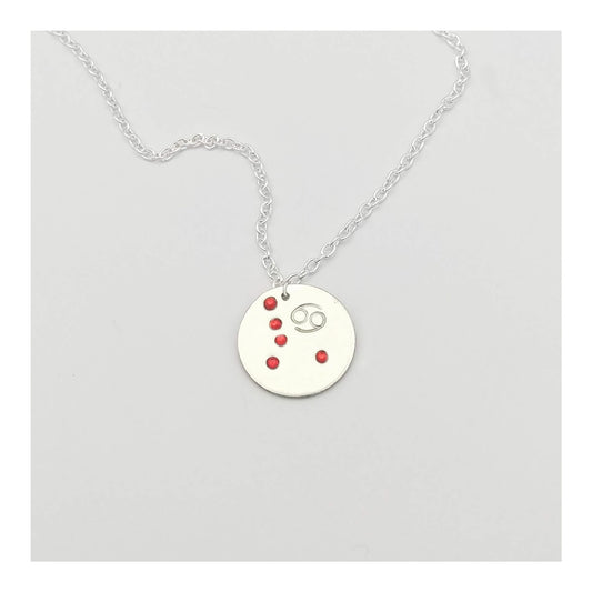 July Cancer necklace pendant with hand set ruby colored glass rhinestones forming the constellation of Cancer. Hand stamped with the zodiac symbol for Cancer, on a 3/4th of an inch silver toned circle hanging from a silver toned chain.