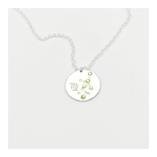 August Virgo necklace pendant with hand set peridot colored glass rhinestones forming the constellation of Virgo. Hand stamped with the zodiac symbol for Virgo, on a 3/4th of an inch silver toned circle hanging from a silver toned chain.