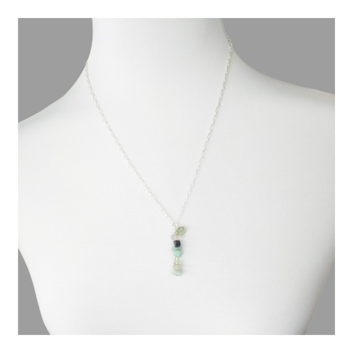 Mercury Retrograde protection necklace has assorted chipped crystals including sodalite, amazonite, blue lace agate, clear quartz, and green fluorite. Hanging on a 20 inch long silver toned chain.  With the gemstones a-lined on a 2 1/4 inch drop in a random but complementary order. 